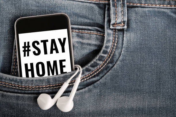istock Mock up with modern smartphone and earphones on denim textile. 1218469439