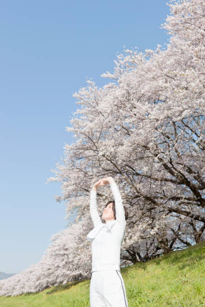 istock Cherry blossoms and women 1218473302