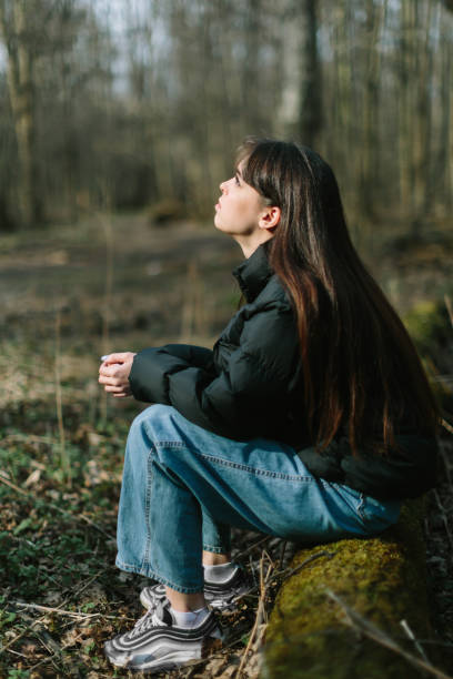 istock young attractive brunette woman alone in wild forest 1218475816
