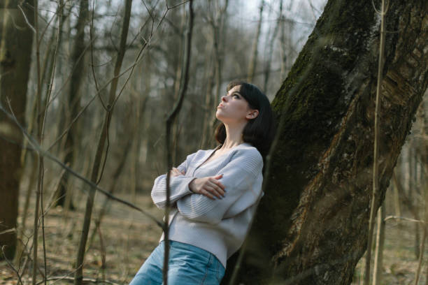 istock young attractive brunette woman alone in wild forest 1218475818