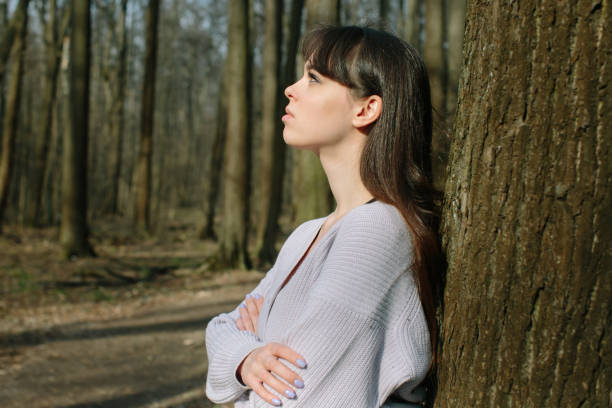 istock young attractive brunette woman alone in wild forest 1218475825