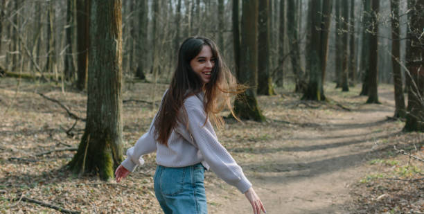 istock young attractive brunette woman alone in wild forest 1218475829