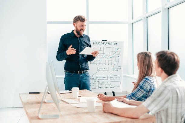 istock entrepreneur with a digital tablet makes a report for the business team 1218478224