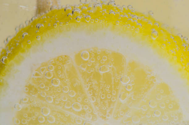 istock An orange falling into the water. Bright background 1218482494