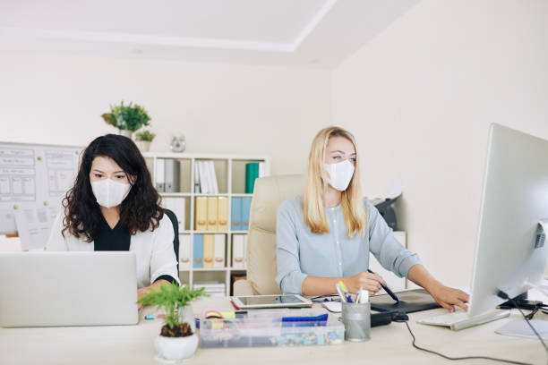 istock Graphic designers working in medical masks 1218486052