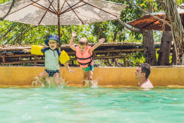 istock two young boys friends jumping in the pool 1218486832