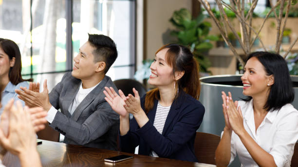 istock Satisfied proud business team clapping hands  in modern office 1218487170