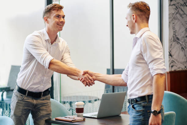 istock Businessman shaking hands of coworker 1218488111