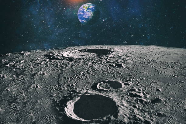 Moon limb with Earth rising on the horizon.Earth rises above lunar horizon. Elements of this image furnished by NASA. stock photo
