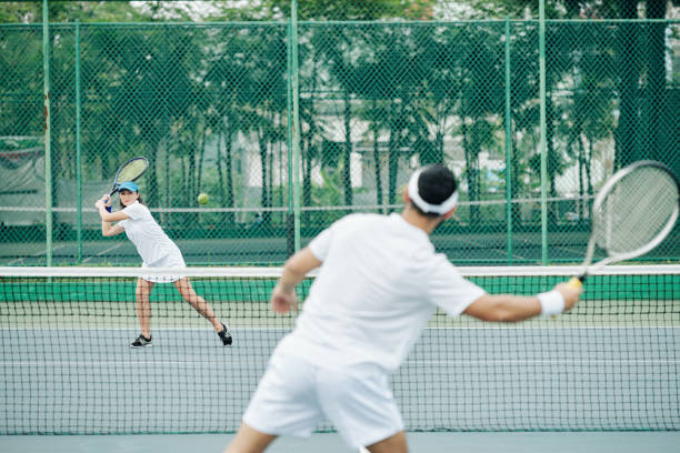 istock Female tennis player hitting ball 1218489062