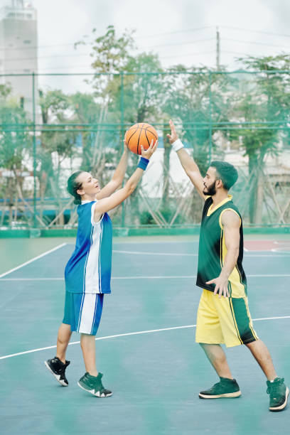 istock Young people playing basketball 1218489069