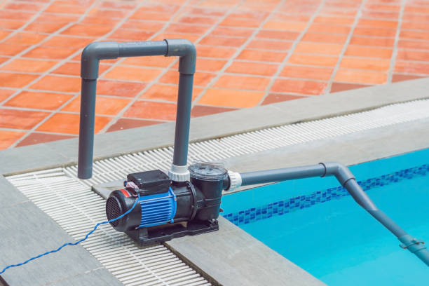 istock Pool vacuum cleaning flexible hose on the pool 1218489218