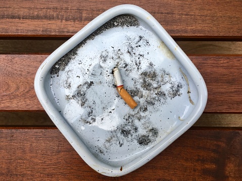 Stop smoking, extinguish a cigarette in ashtray dish