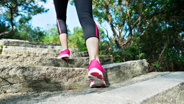 istock Woman feet walking on the steps 1218491712