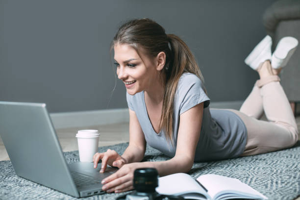 istock Young woman using laptop, communicates on internet with customer. Cozy office at home. 1218492722