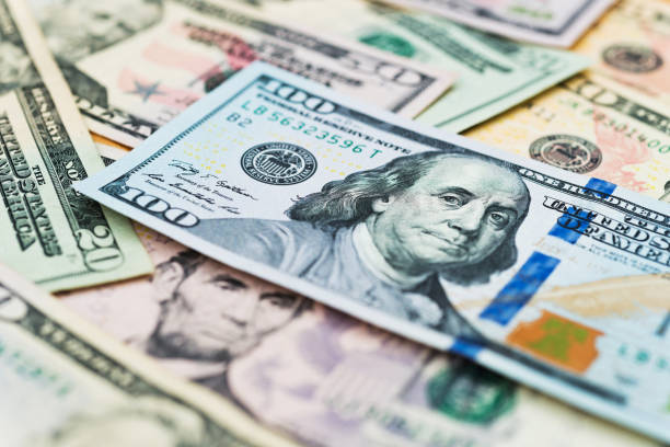 istock Group of dollar bills background 1218494352