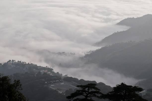 istock top bird view of mountains at sunset with fog & clouds 1218497521