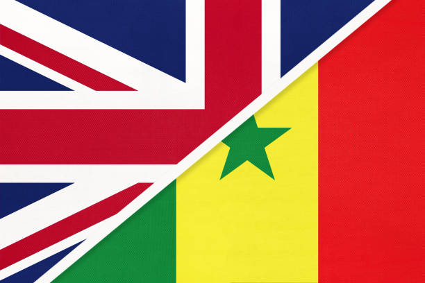 великобритания против сенегала национальный флаг из текстиля. отношения между двумя европейскими и африканскими странами. - england senegal stock illustrations