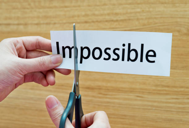 istock Human hand cutting word on paper unknown become possible 1218498451
