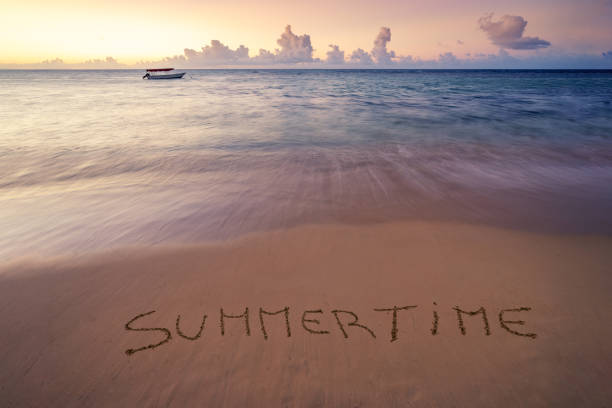 istock Handwritten Summertime on sandy beach at sunset 1218498456