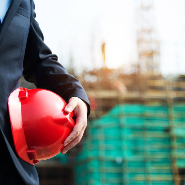istock Businessman holding a hardhat under his arm 1218499704
