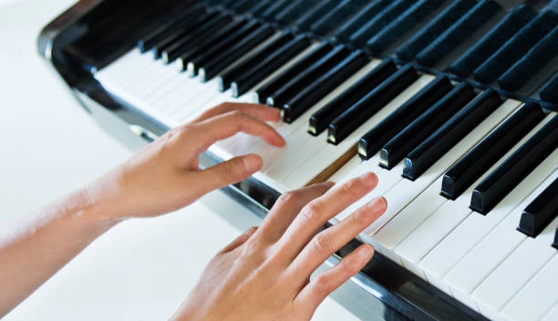 istock Woman hand playing the piano 1218501626