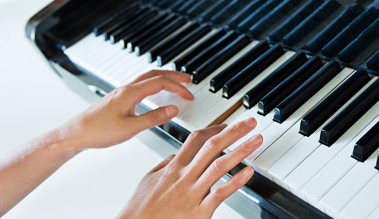 Woman hand playing the piano