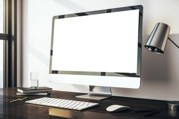 istock Computer with blank white screen on wooden desk, chair and lamp. Mockup. 3D Rendering 1218501997
