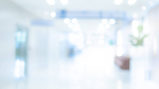 Blurred luxury hospital interior background Abstract blur luxury hospital hall. Blur clinic corridor interior background with defocused effect. Healthcare and medical concept blue light room stock pictures, royalty-free photos & images