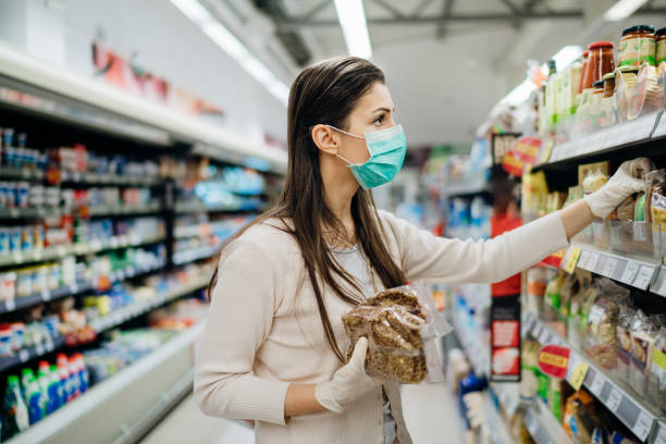 istock Shopping during an epidemic.Buyer wearing a protective mask.Nonperishable smart purchased household pantry groceries.Pandemic quarantine preparation.Dry goods and nutritional foods shopping.Expiration 1218503184