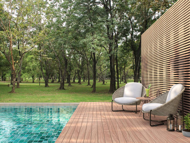 Swimming pool terrace with garden view 3d render Swimming pool terrace with garden view 3d render,  There are a wooden floor ,green tile in the swimming pool and ,wooden lath wall,Decorated with rattan furniture,Surrounded by nature. building terrace stock pictures, royalty-free photos & images