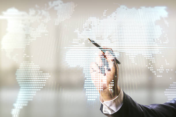 istock Multi exposure of businessman hand with pen working with abstract creative digital world map hologram on blurred office background, research and analytics concept 1218503513