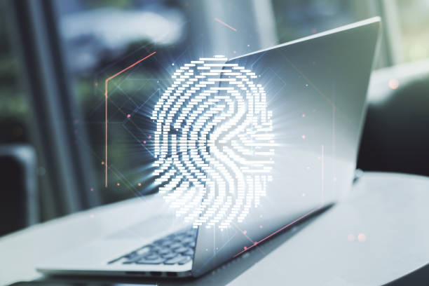 istock Multi exposure of creative fingerprint hologram on laptop background, personal biometric data concept 1218504094