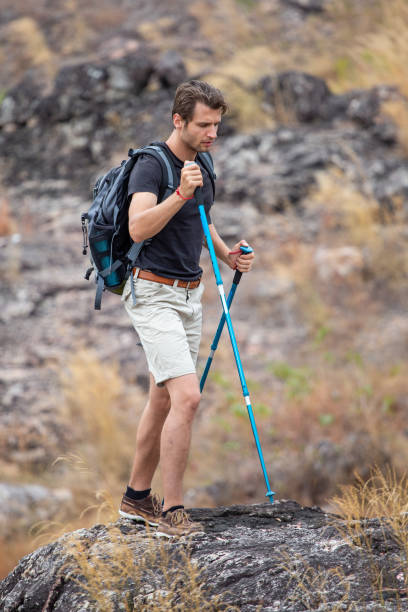 istock Hiker man hiking on rock in mountains 1218505546