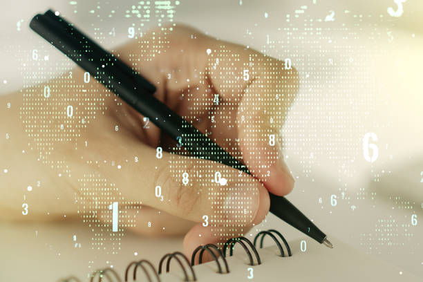 istock Multi exposure of abstract software development hologram with world map and man hand writing in notebook on background, global research and analytics concept 1218506284