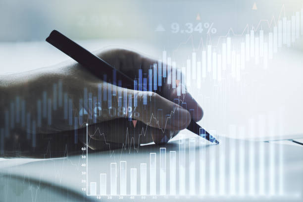 istock Multi exposure of abstract financial graph with hand writing in notebook on background, financial and trading concept 1218506456