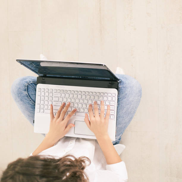 istock young woman using laptop. Top view girl hands at computer keyboard. Lifestyle 1218506629
