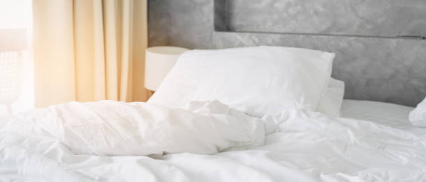 istock wrinkle white messy blanket on bed in bedroom in morning, panorama 1218506779