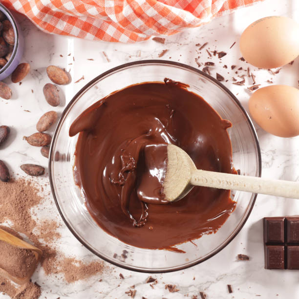 istock melted chocolate in bowl with wooden spoon and ingredient 1218506902