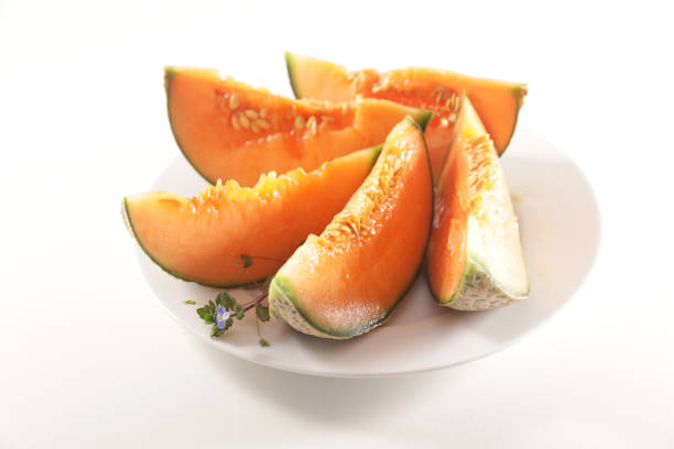 istock melon slices on plate isolated on white background 1218506905