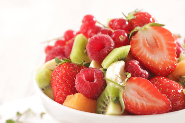 istock closeup on fruit salad with berry fruit, banana, kiwi 1218507744
