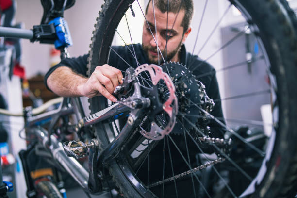 istock Mechanic Repairs Brake Disc To Bicycle 1218507772