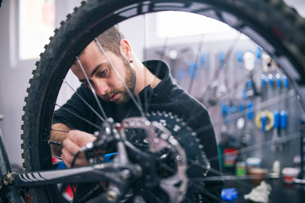 istock Mechanic Repairing Bicycle  Transmission 1218507774
