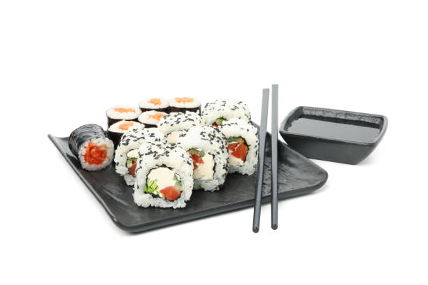 istock Tray with sushi rolls, chopsticks and soy sauce isolated on white background 1218509156