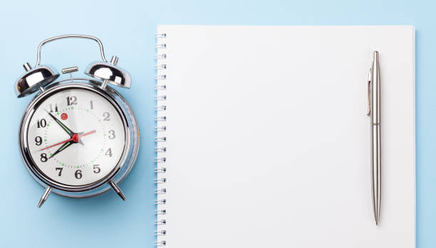 istock Blue workplace with supplies and alarm clock 1218512833
