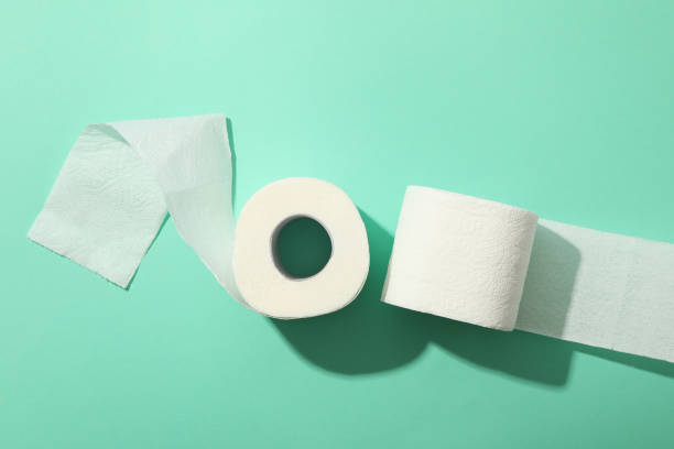 istock Toilet paper on mint background, top view 1218514128
