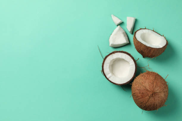 istock Coconut on mint background, top view and space for text 1218515330