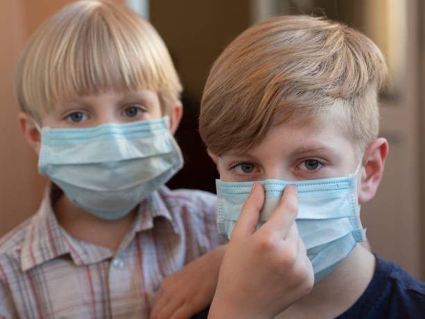 istock Young boys wearing face mask 1218515333