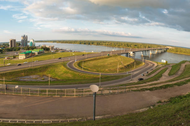 Panoramic picture of road and cars driving, summer sunny day in Barnaul, Siberia, Russia