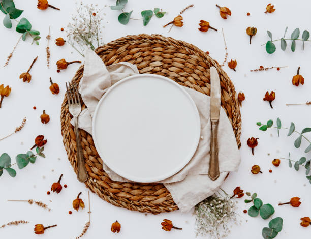 istock Table setting mock-up scene. Porcelain plate and cutlery. With flowers and eucalyptus, top view, flat lay. White table background. 1218516608